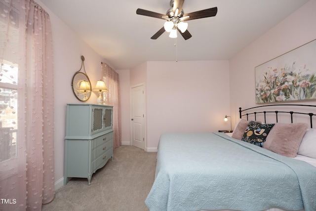 bedroom with baseboards, light colored carpet, and ceiling fan