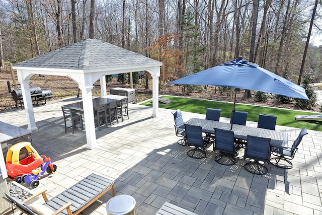 view of patio / terrace featuring a gazebo, outdoor dining space, and outdoor dry bar