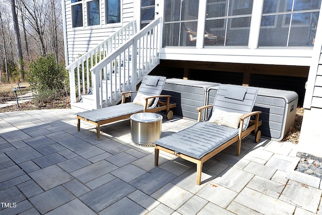 view of patio with stairway and a sunroom