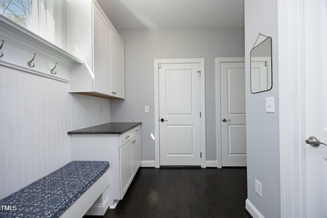 interior space featuring dark countertops, white cabinets, baseboards, and dark wood-style flooring