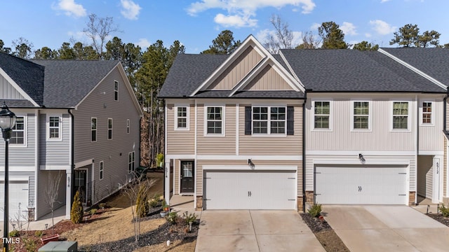 view of front of house with driveway, a shingled roof, stone siding, an attached garage, and board and batten siding