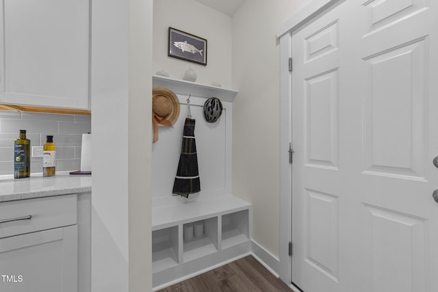 mudroom featuring dark wood-style floors and baseboards