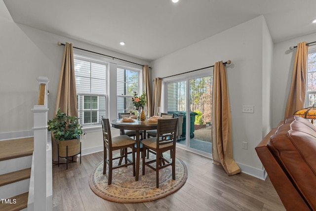 dining space featuring recessed lighting, wood finished floors, and baseboards