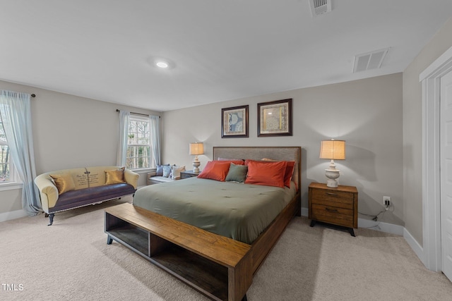 carpeted bedroom featuring visible vents and baseboards