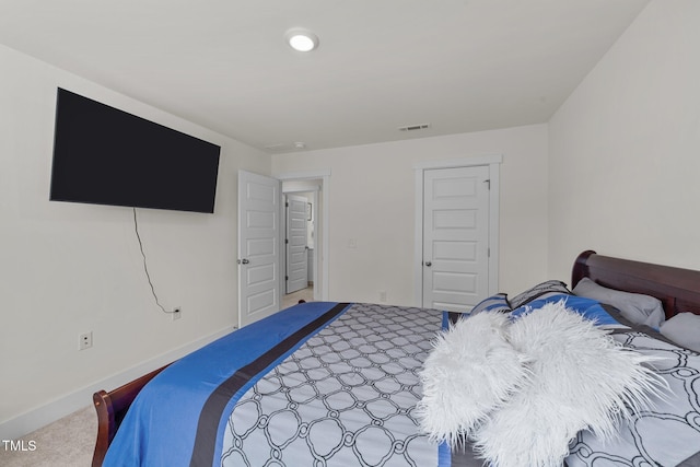 bedroom with carpet floors, visible vents, and baseboards