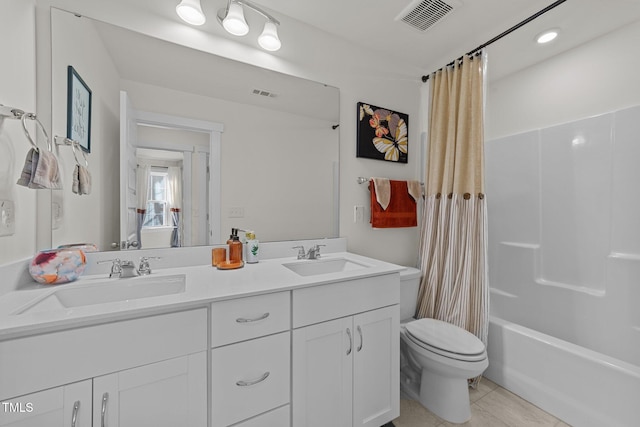 bathroom featuring toilet, a sink, and visible vents