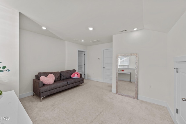 living room with light carpet, visible vents, and baseboards