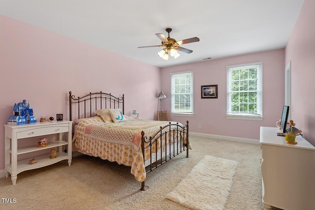 bedroom featuring light carpet, ceiling fan, and baseboards