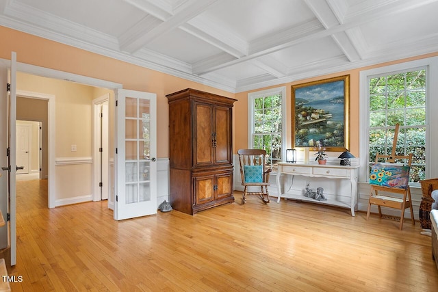 unfurnished room with light wood finished floors, coffered ceiling, crown molding, french doors, and beam ceiling