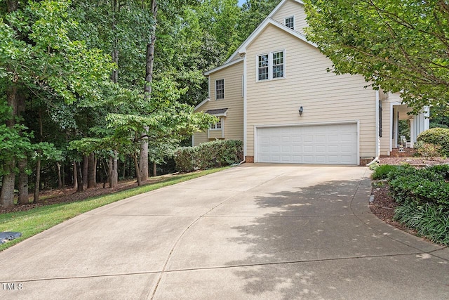 exterior space with a garage and concrete driveway