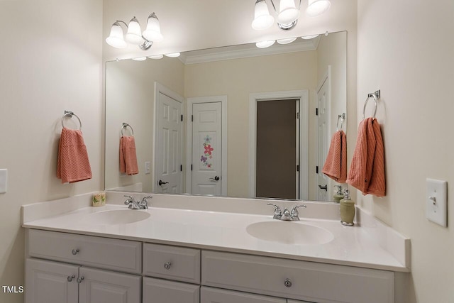 full bathroom with double vanity, crown molding, and a sink