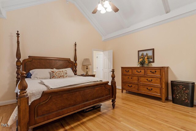 bedroom featuring baseboards, light wood finished floors, and crown molding