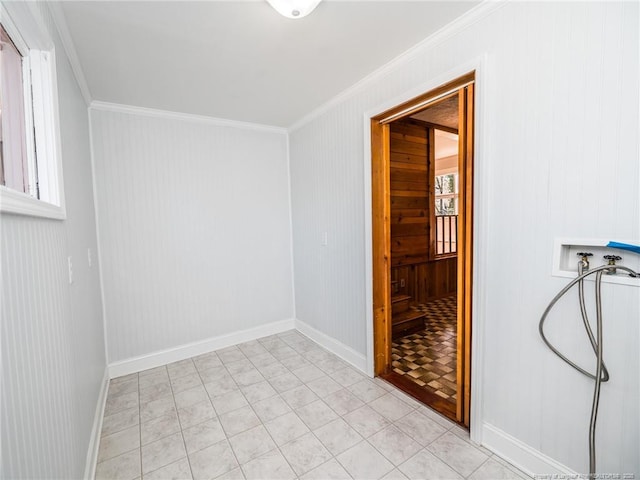 unfurnished room featuring baseboards and crown molding