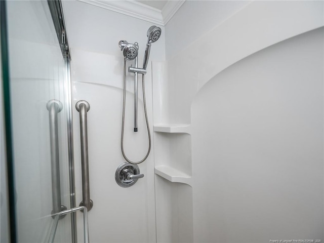 interior details featuring walk in shower and crown molding