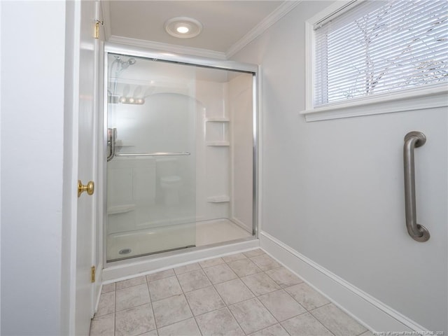 bathroom with ornamental molding, tile patterned flooring, a shower with shower door, and baseboards