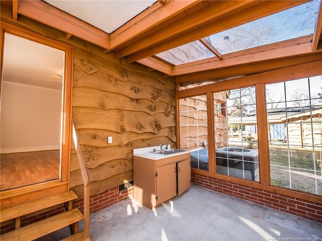 sunroom featuring a skylight and a sink