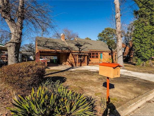 view of front of home featuring a chimney