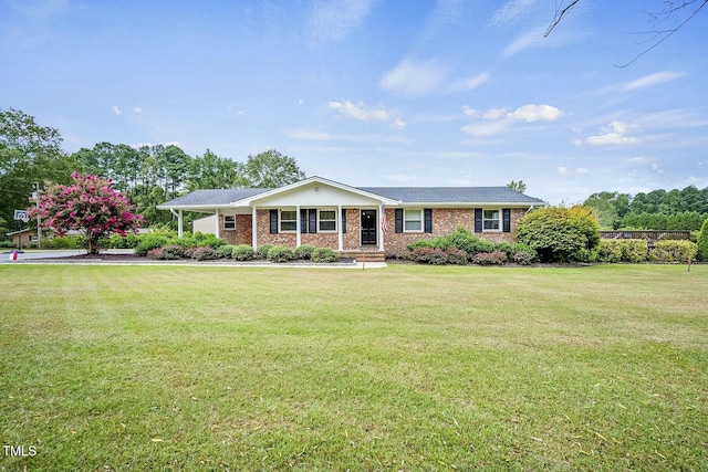 single story home featuring brick siding and a front yard