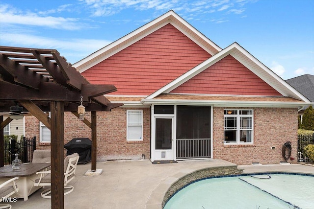 back of house featuring a patio, brick siding, a sunroom, a fenced in pool, and a pergola