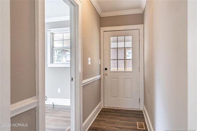 entryway with dark wood-style flooring, visible vents, crown molding, and baseboards