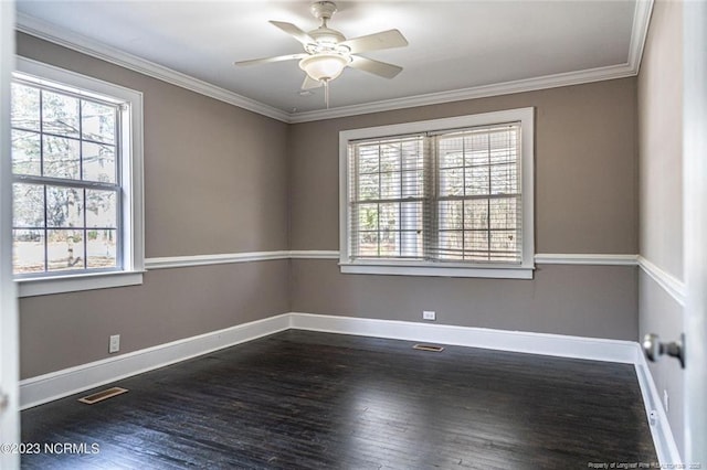 spare room with ceiling fan, dark wood finished floors, visible vents, and crown molding