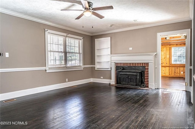 unfurnished living room featuring ornamental molding, dark wood-type flooring, a textured ceiling, and baseboards