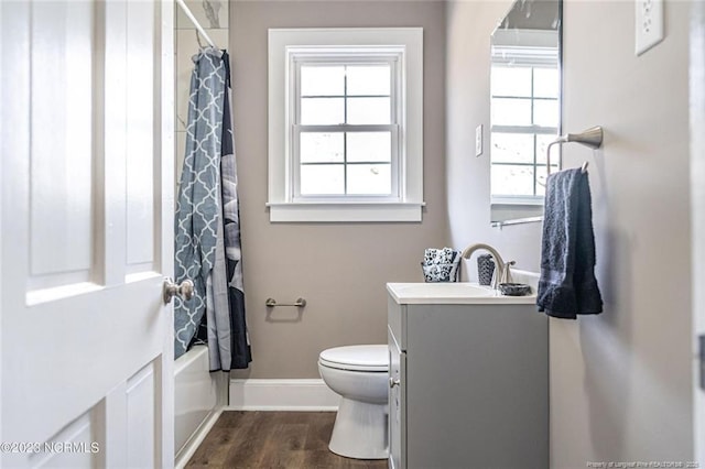 full bath featuring shower / bath combination with curtain, toilet, vanity, wood finished floors, and baseboards