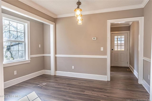 unfurnished dining area with ornamental molding, visible vents, dark wood finished floors, and baseboards