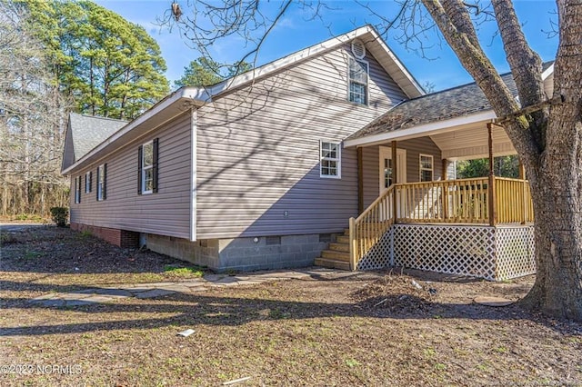 back of house featuring a porch, crawl space, and a shingled roof