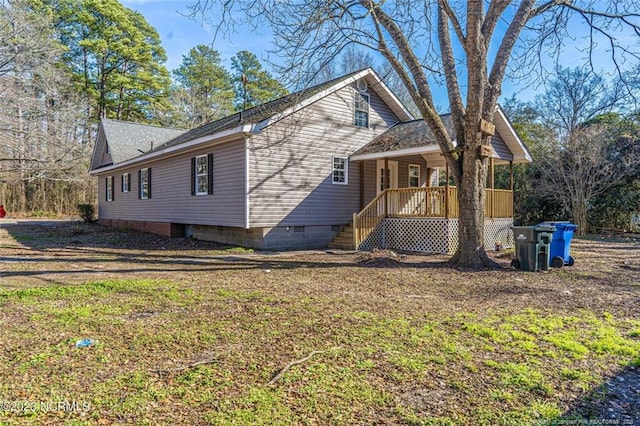 view of property exterior with crawl space and covered porch