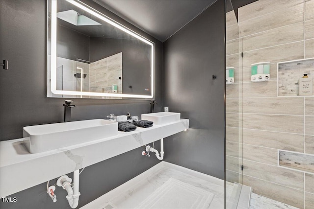 full bath featuring a walk in shower, a sink, and lofted ceiling