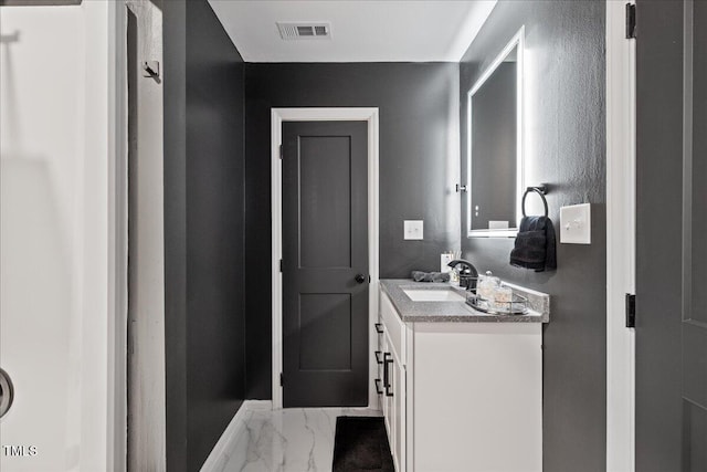 bathroom featuring marble finish floor, visible vents, and vanity