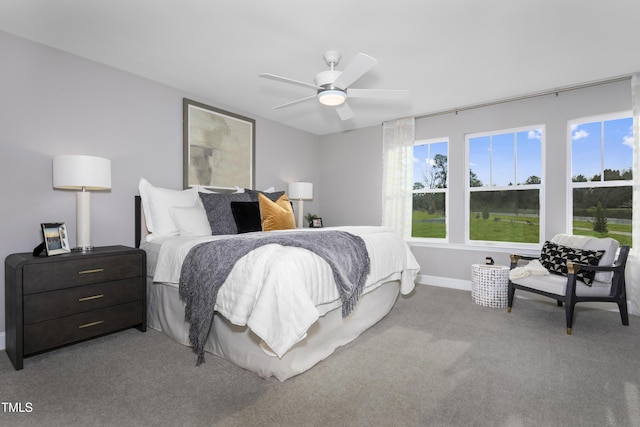 carpeted bedroom with a ceiling fan and baseboards