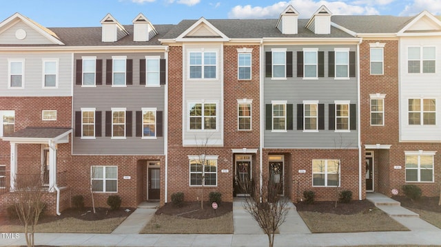 view of property featuring brick siding