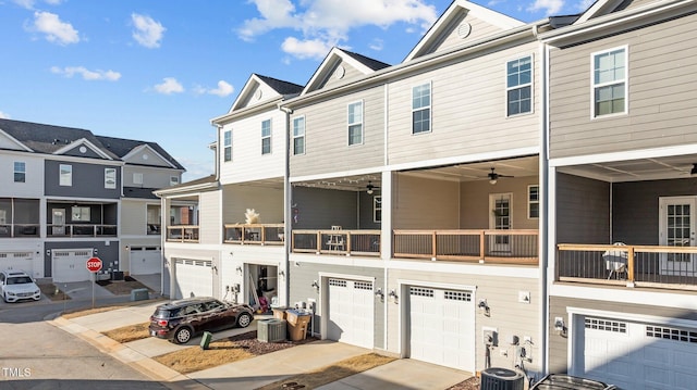 multi unit property featuring a garage and central AC unit