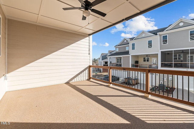 balcony featuring a ceiling fan, a residential view, and a patio