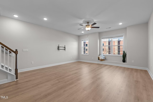 unfurnished living room with recessed lighting, a ceiling fan, baseboards, light wood-style floors, and stairway