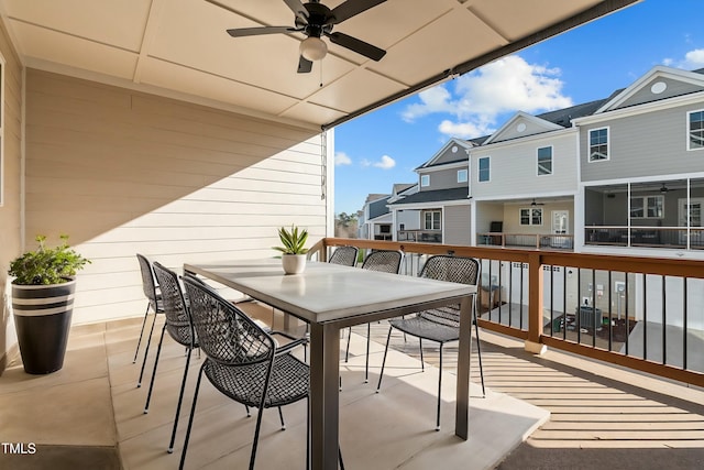 balcony featuring a ceiling fan, a residential view, and outdoor dining area