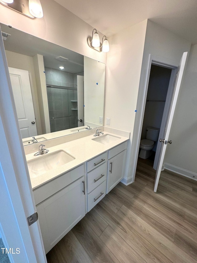 332 Church St Unit 45, Wendell, NC 27591 - bathroom with double vanity, wood finished floors, a shower stall, toilet, and baseboards