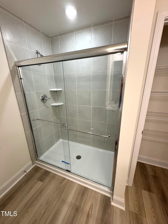 332 Church St Unit 45, Wendell, NC 27591 - bathroom with a stall shower, wood finished floors, baseboards, and a spacious closet