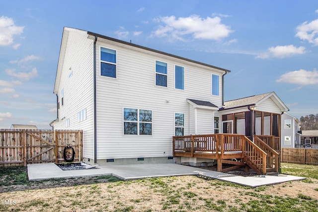 rear view of property with a deck, a patio, fence, crawl space, and a gate