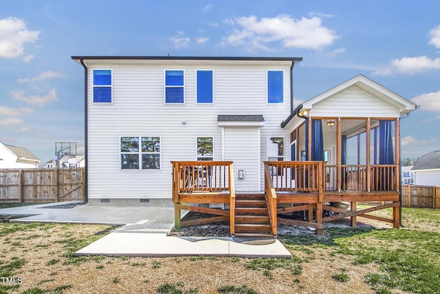 rear view of property with a patio, a sunroom, crawl space, fence private yard, and a wooden deck