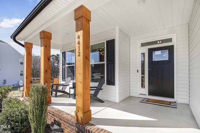 view of exterior entry with covered porch