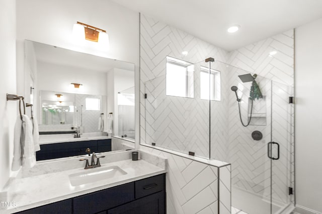 full bathroom with a shower stall and vanity