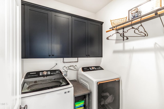 washroom with cabinet space and washer and clothes dryer