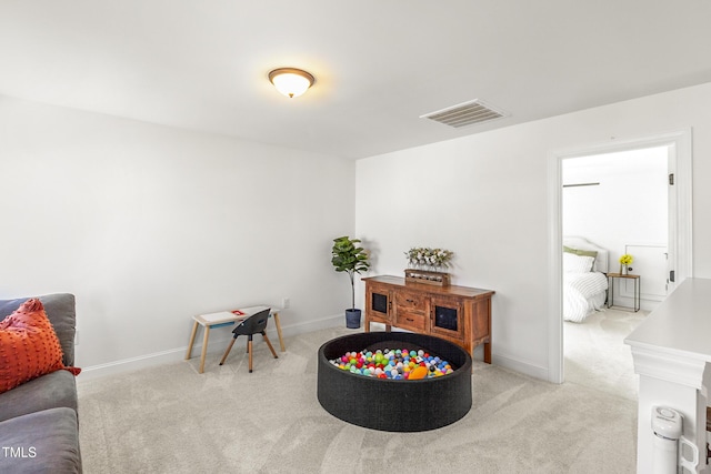 recreation room with carpet, visible vents, and baseboards