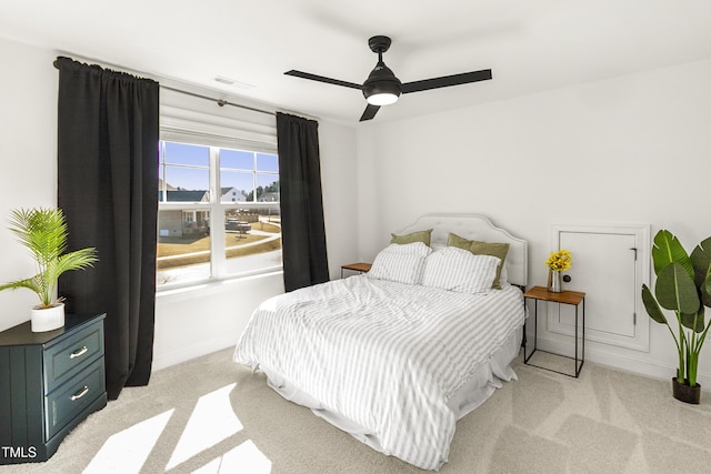 bedroom featuring light carpet, ceiling fan, and visible vents