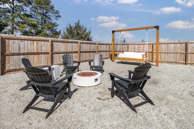 view of patio featuring an outdoor fire pit and a fenced backyard