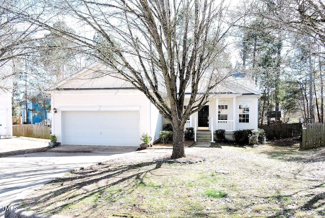 view of front of house featuring a garage, covered porch, and fence