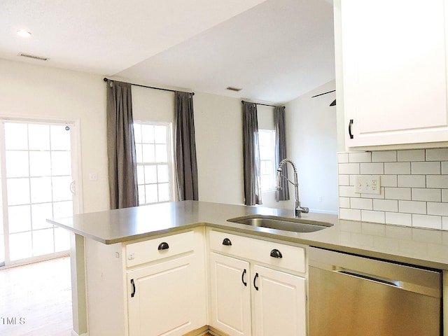 kitchen with a sink, plenty of natural light, visible vents, and dishwasher